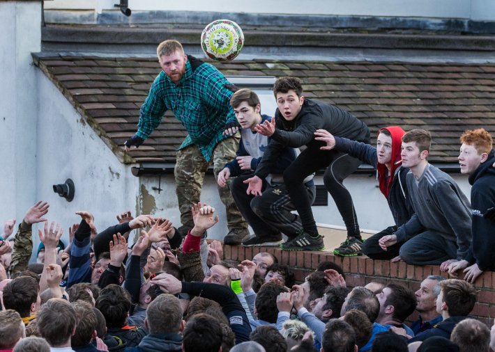  Participants watch as the ball is thrown during Shrovetide football in Ashbourne 